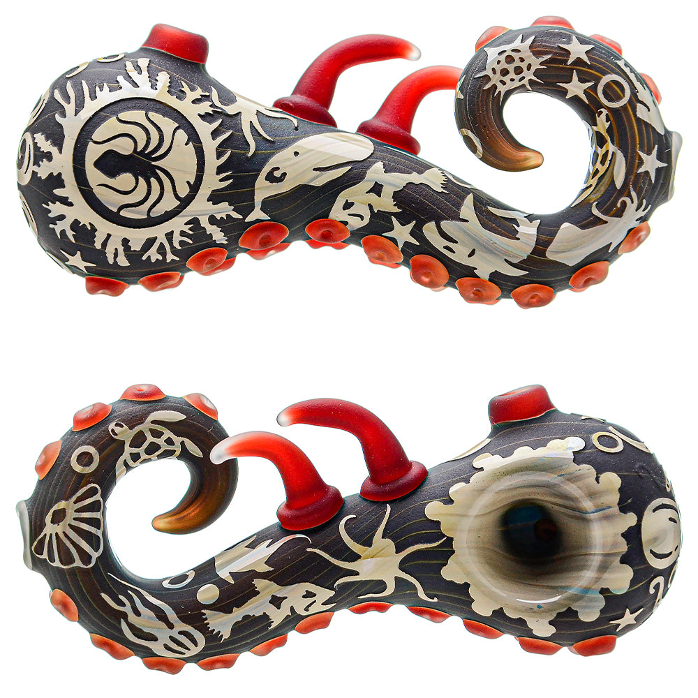 A smoking pipe with a sandblasted sealife design, featuring a dark color palette and red accents.