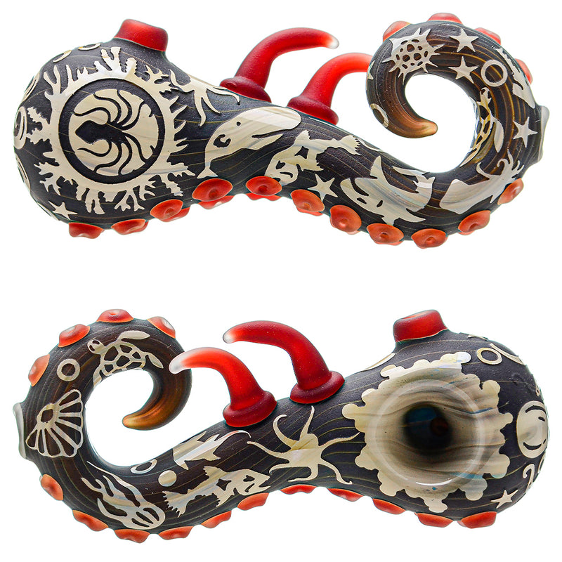A smoking pipe with a sandblasted sealife design, featuring a dark color palette and red accents.