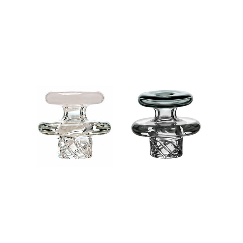 Two Calibear Universal Vortex Spinner Carb Caps, featuring one clear glass option and one smoked grey glass option, showcasing the precision spiral airflow grooves on the bottom stem and a wide sealing ridge.